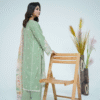 A model wearing a mint green embroidered Eid dress with lace detailing and printed dupatta – Amzoclothing Summer Festive Collection 2025.