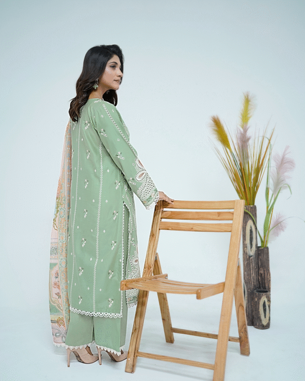A model wearing a mint green embroidered Eid dress with lace detailing and printed dupatta – Amzoclothing Summer Festive Collection 2025.