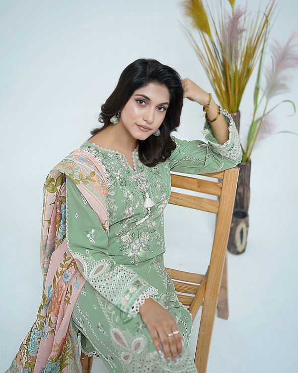 A model wearing a mint green embroidered Eid dress with lace detailing and printed dupatta – Amzoclothing Summer Festive Collection 2025.