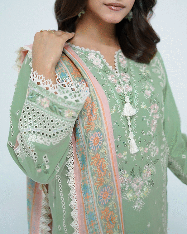 A model wearing a mint green embroidered Eid dress with lace detailing and printed dupatta – Amzoclothing Summer Festive Collection 2025.