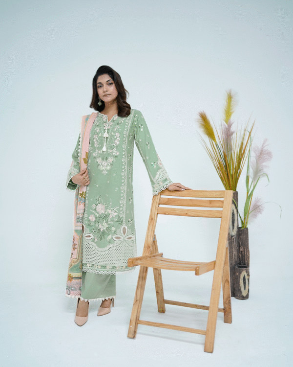 A model wearing a mint green embroidered Eid dress with lace detailing and printed dupatta – Amzoclothing Summer Festive Collection 2025.