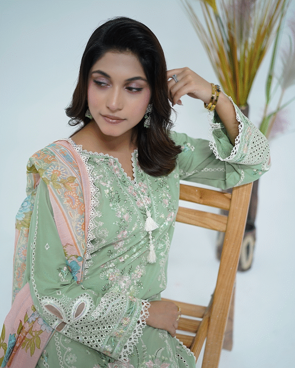 A model wearing a mint green embroidered Eid dress with lace detailing and printed dupatta – Amzoclothing Summer Festive Collection 2025.