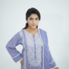 A model wearing Amzoclothing’s Cerulean Blue 3-piece embroidered lawn suit with white threadwork and ombre chiffon dupatta – Eid and summer festive wear 2025.