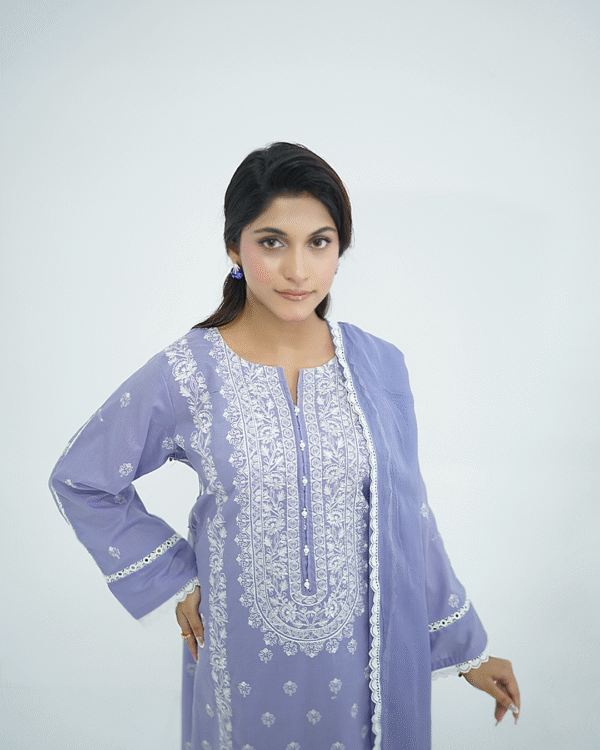 A model wearing Amzoclothing’s Cerulean Blue 3-piece embroidered lawn suit with white threadwork and ombre chiffon dupatta – Eid and summer festive wear 2025.