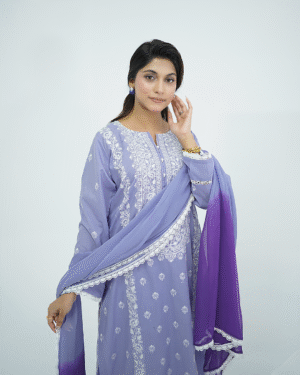 A model wearing Amzoclothing’s Cerulean Blue 3-piece embroidered lawn suit with white threadwork and ombre chiffon dupatta – Eid and summer festive wear 2025.