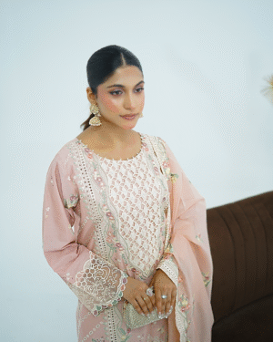 Model wearing Dessert rose pink embroidered cotton dress with cutwork neckline, organza sleeves, and heavy dupatta by Amzoclothing