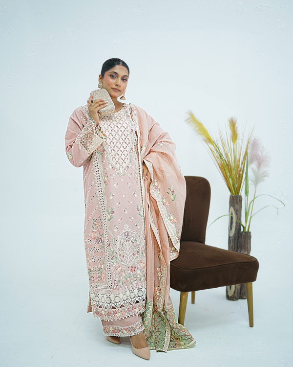 Model wearing rose pink embroidered cotton dress with cutwork neckline, organza sleeves, and heavy dupatta by Amzoclothing