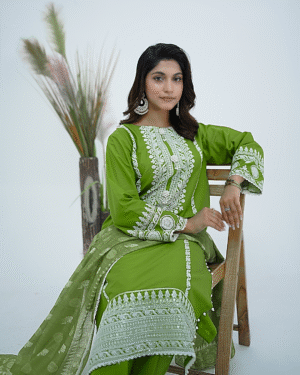 A model wearing lLime Twist - Luxury Stitched cotton embroidered dress with sequin and pearl detailing, paired with a printed viscose dupatta – Amzoclothing Festive Collection 2025.