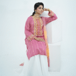 Model in pink embroidered lawn Eid dress with pearl details, white sharara pants, and printed net dupatta – Amzoclothing Eid 2025.