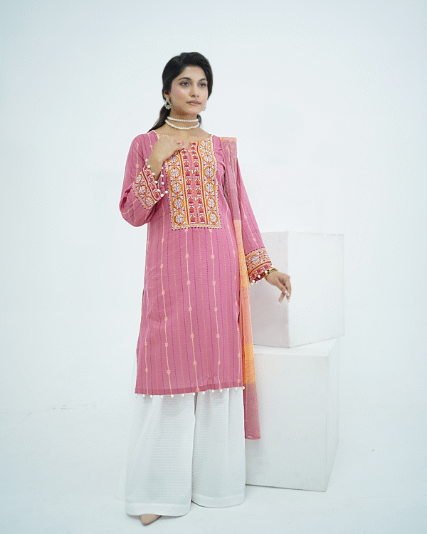 Model in pink embroidered lawn Eid dress with pearl details, white sharara pants, and printed net dupatta – Amzoclothing Eid 2025.