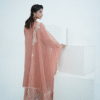 A model wearing a peach embroidered lawn Eid dress with intricate boring design and organza border, paired with a cotton net dupatta with embroidered borders – Amzoclothing festive collection.