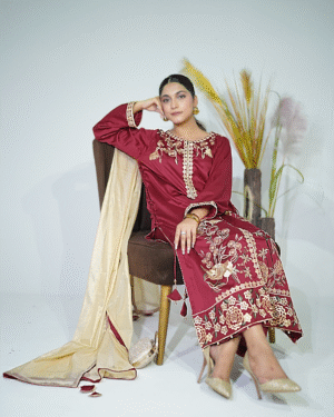 A model wearing a maroon elegance gold sequin embroidered festive shirt with masuri gold dupatta featuring traditional tassel hangings – Eid/wedding outfit by Amzoclothing.