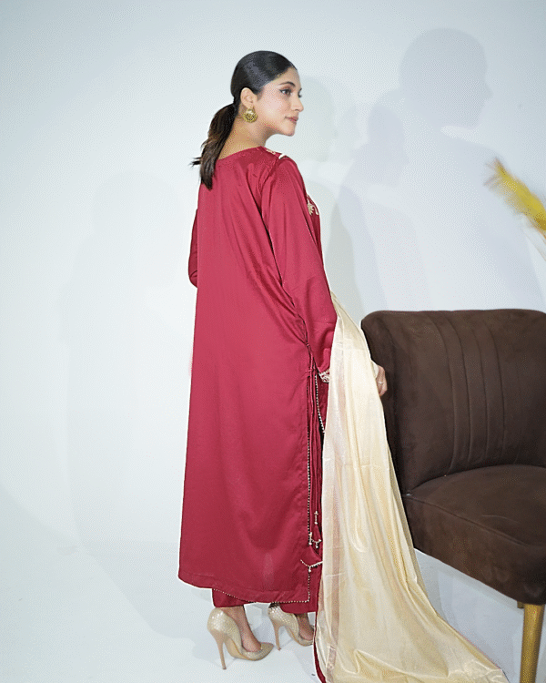 A model wearing a gold sequin embroidered festive shirt with masuri gold dupatta featuring traditional tassel hangings – Eid/wedding outfit by Amzoclothing.